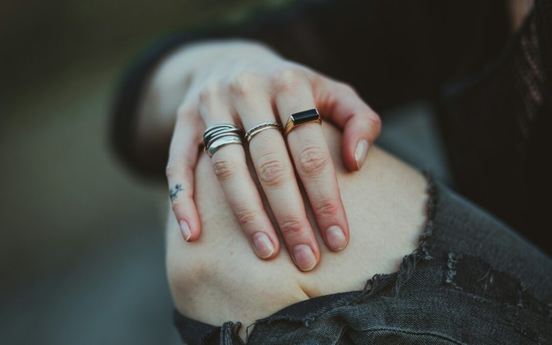photo of person showing silver-colored ring
